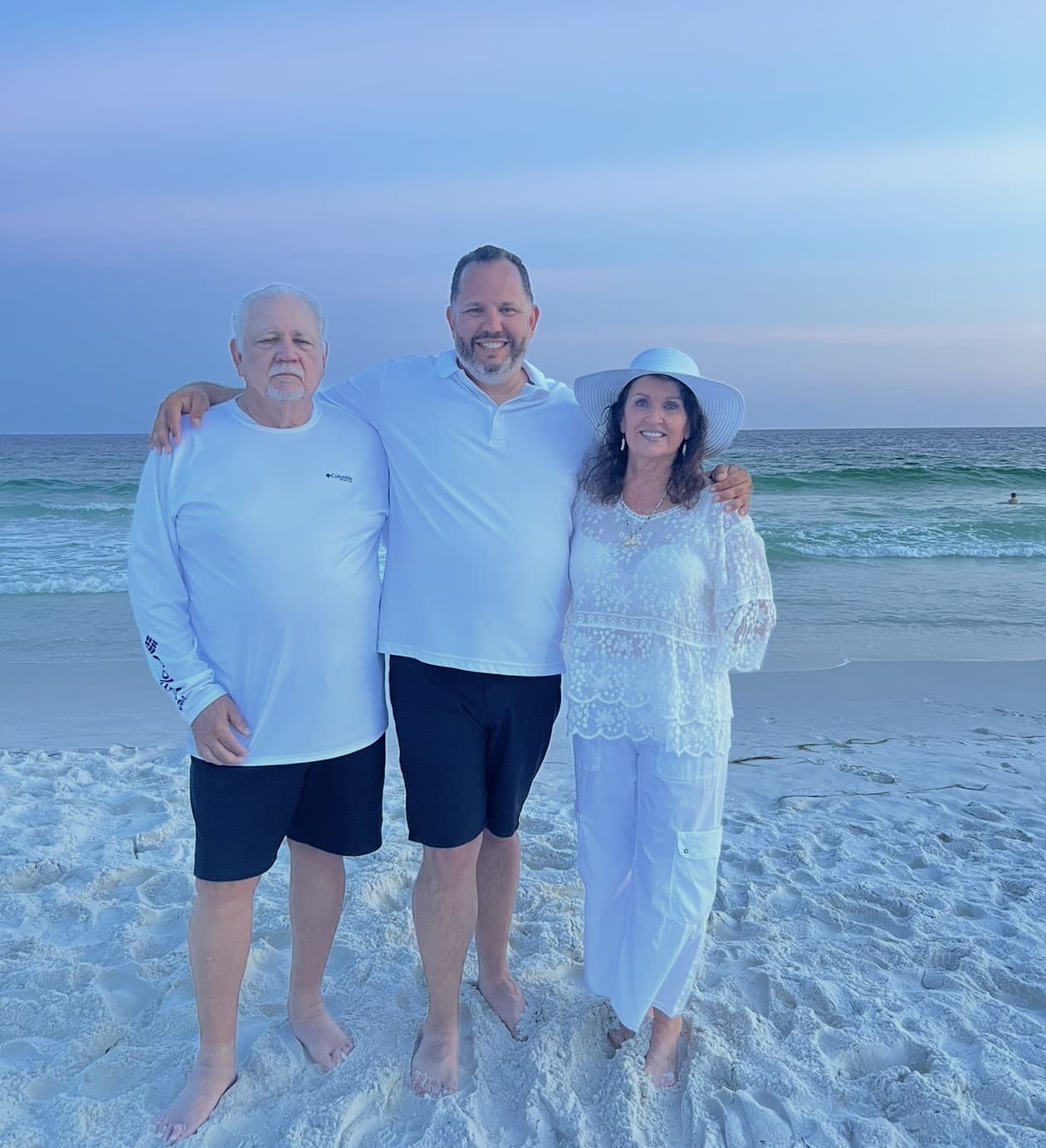 Jason with his parents on the beach