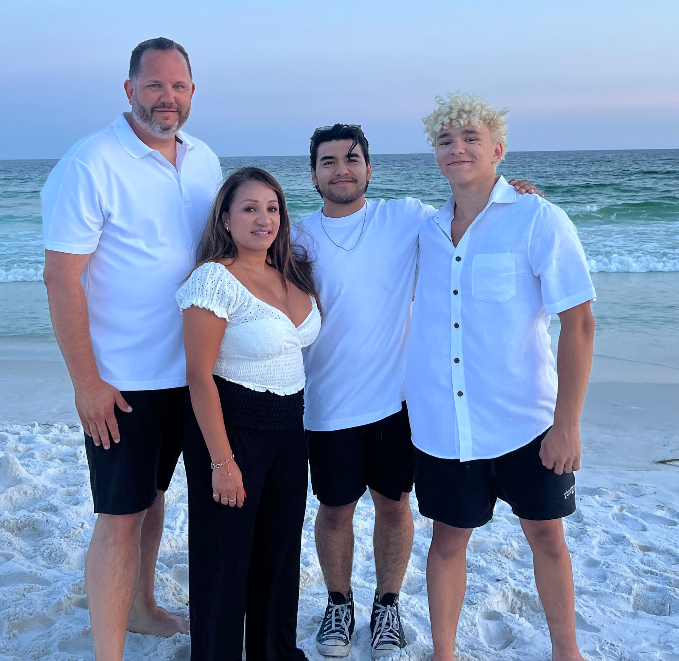 Jason with his wife Maria and their two sons, Tony and Kaleb, on the beach in Destin
